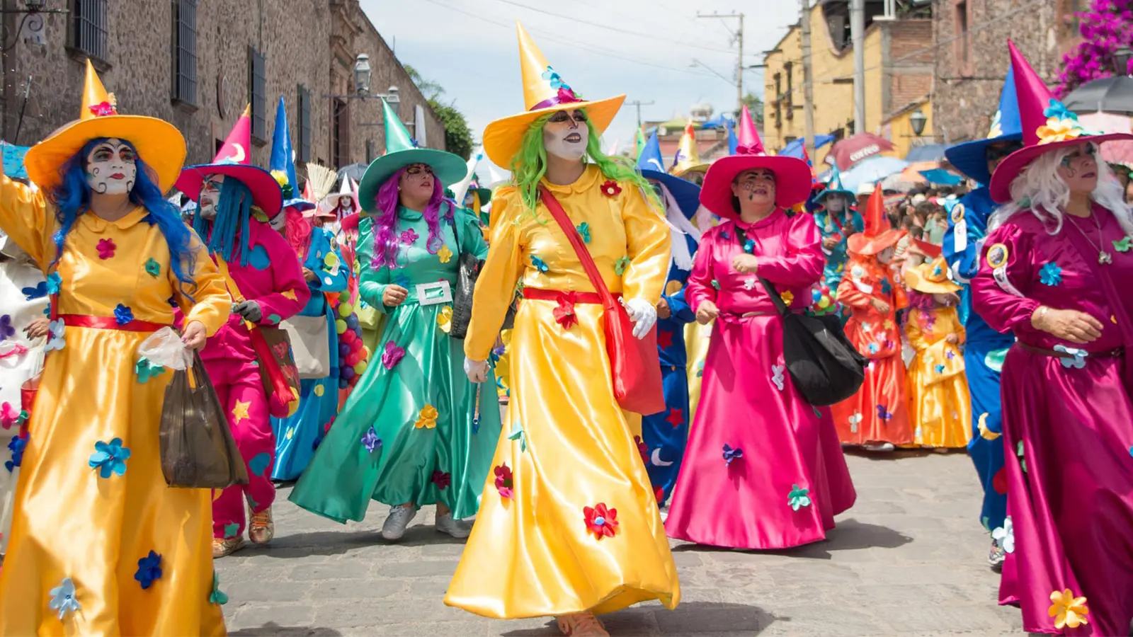 A-Guide-to-San-Miguel-de-Allende’s-Festivals-and-Events - Colonial Real Estate Participants dressed in colorful costumes and face paint during a festive parade in San Miguel de Allende.