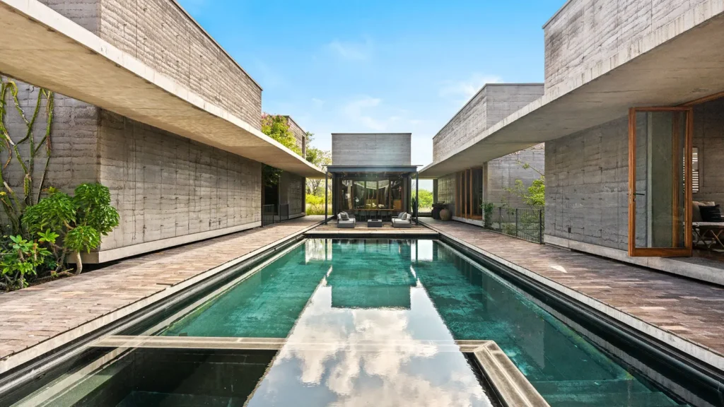 Modern luxury residence in San Miguel de Allende featuring minimalist architecture, concrete textures, and a reflecting pool.