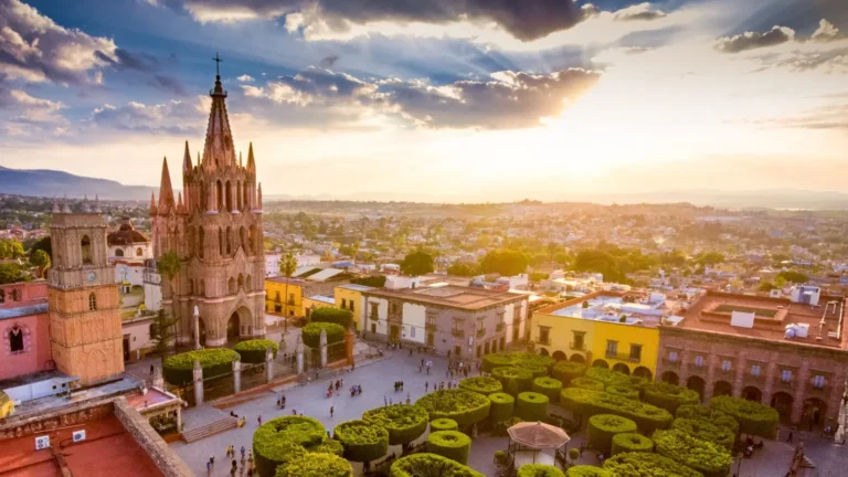Aerial view of San Miguel de Allende at sunset showcasing the Parroquia and historic city center — a symbol of luxury living and cultural heritage in Mexico.