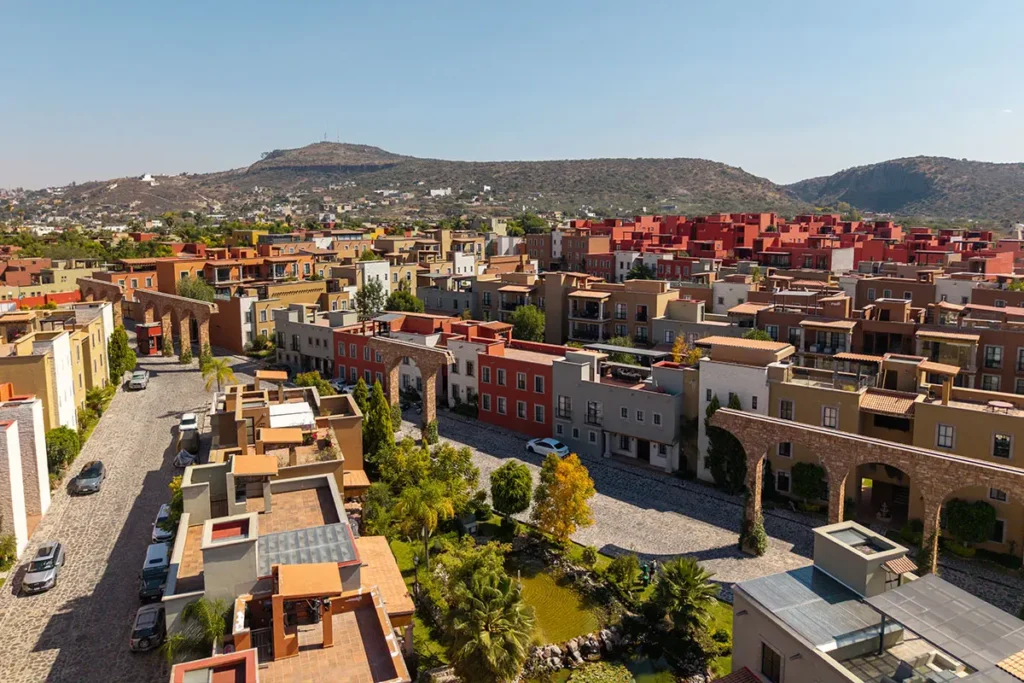 Aerial view of residential homes with mountain backdrop in Paseo Real San Miguel de Allende