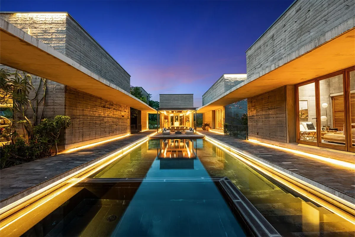 Modern luxury home in San Miguel de Allende with a central reflecting pool, ambient lighting, and contemporary architecture at sunset.