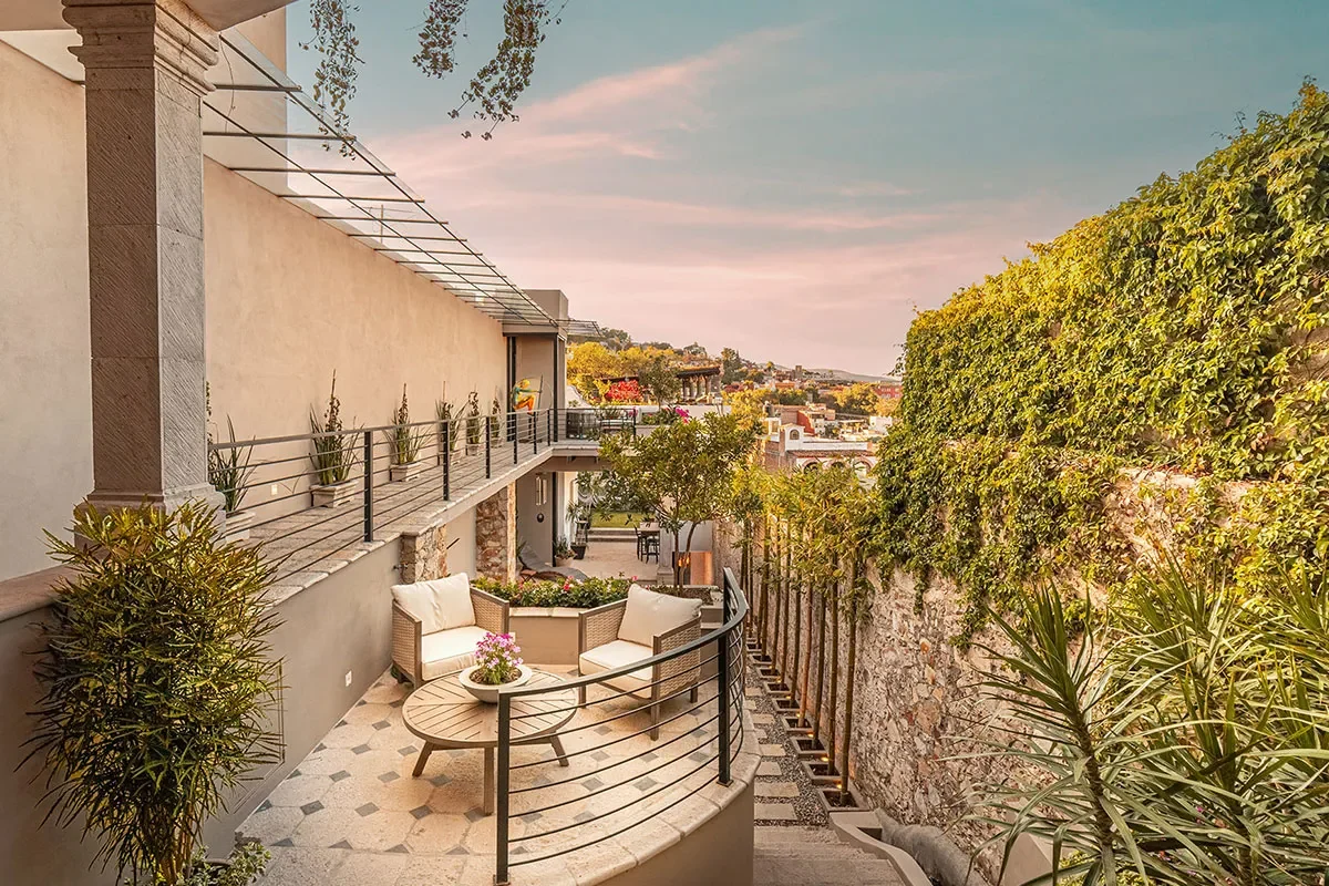 Charming multi-level terrace with garden views and sunset-lit rooftops in San Miguel de Allende